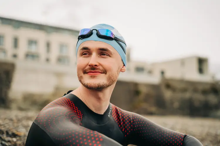 Young male swimmer smiling outdoors after his successful PRK eye surgery.