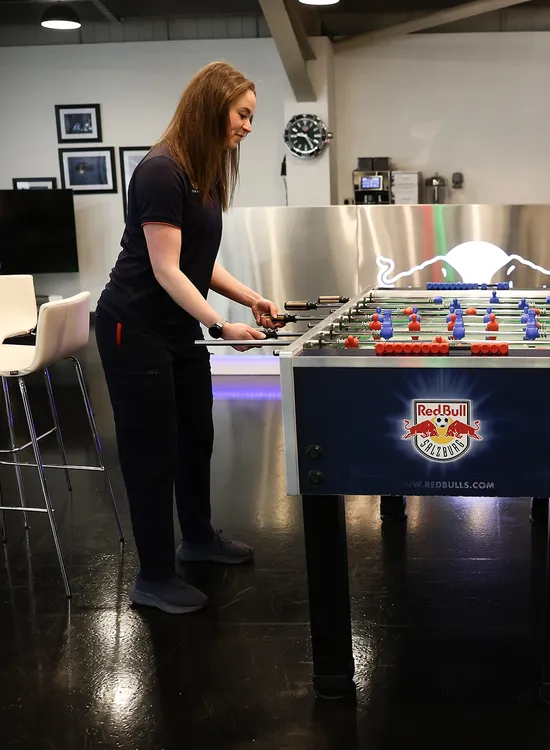 Two team members competing in a game of foosball