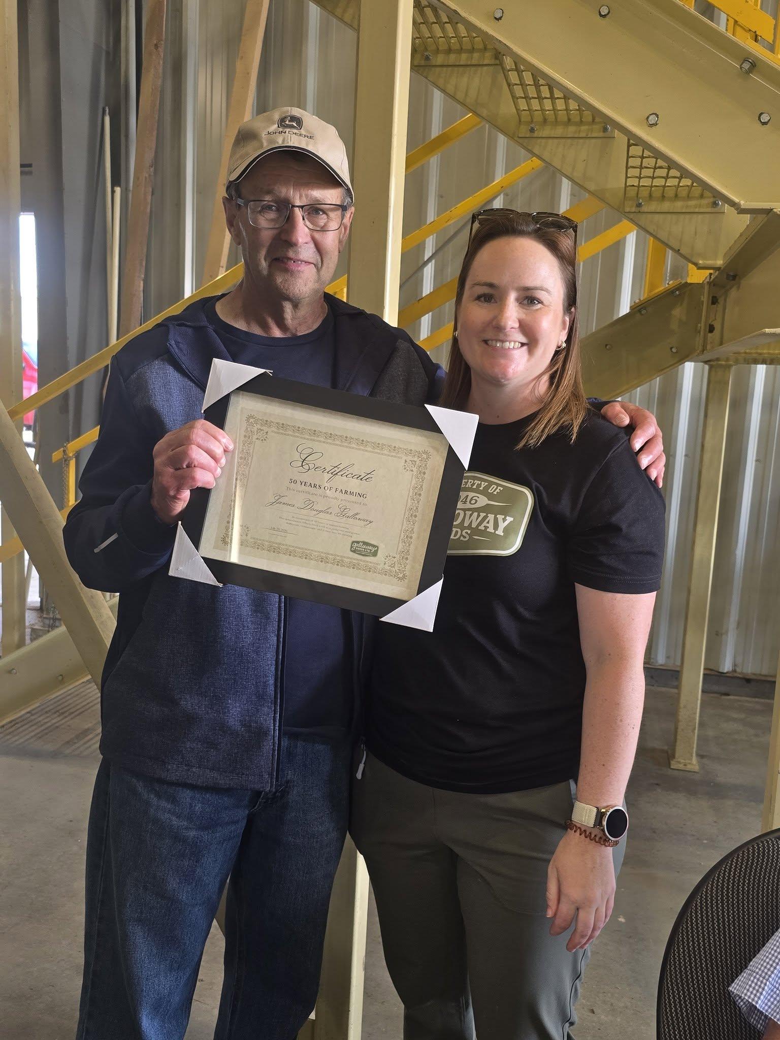 Marking fifty years of farming with a framed certificate