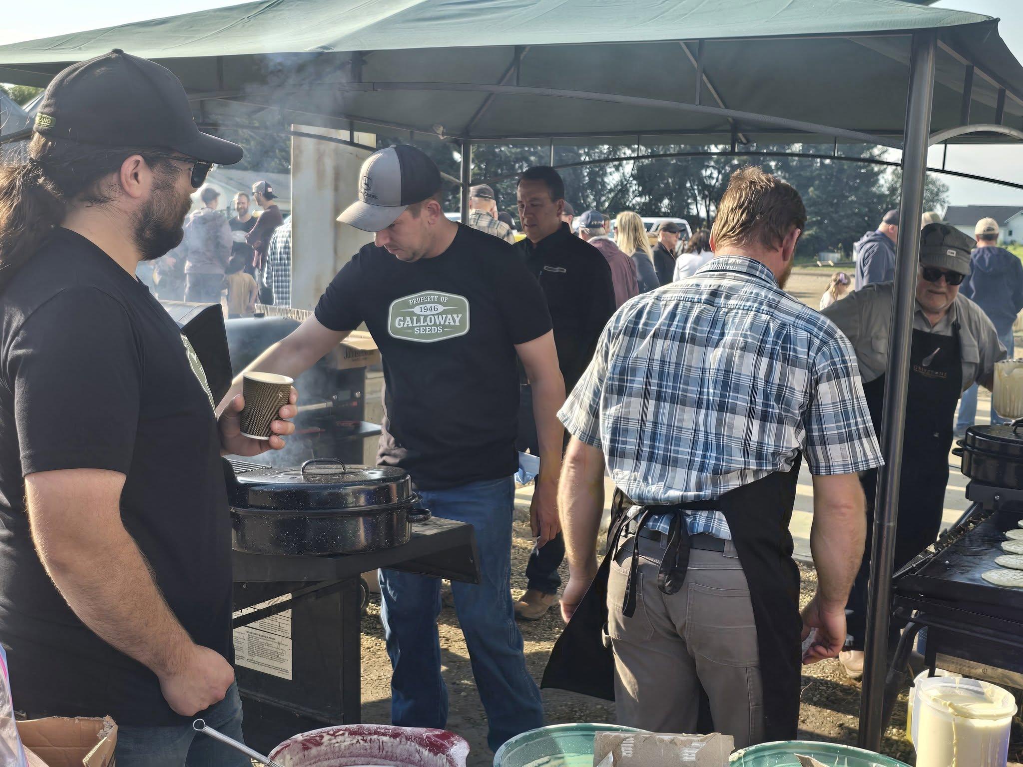 Serving breakfast under the tent as the crowd files past