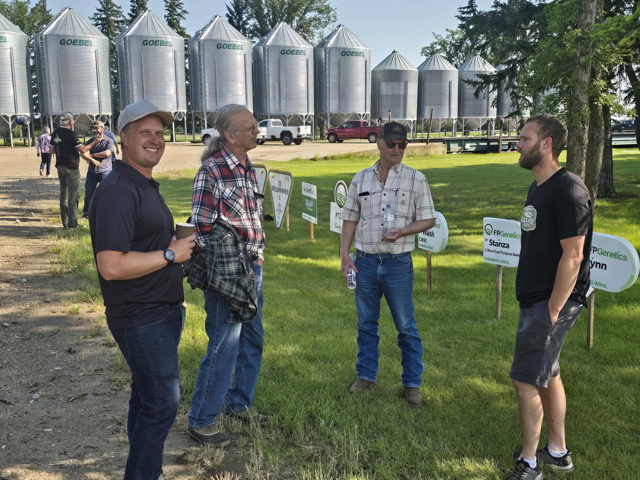 Talking varieties beside the plot signs on the lawn