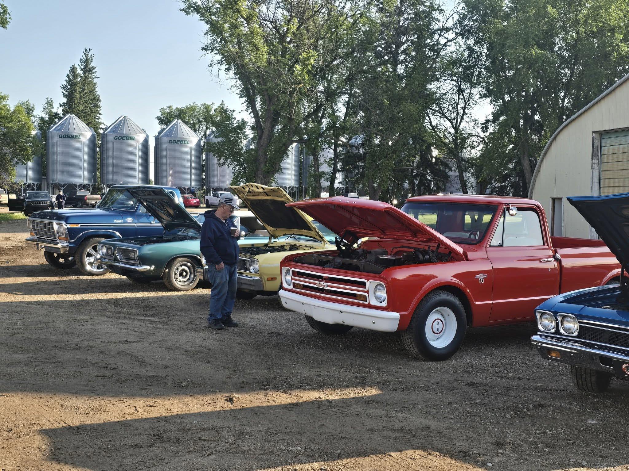 Classic trucks and cars on display in the yard