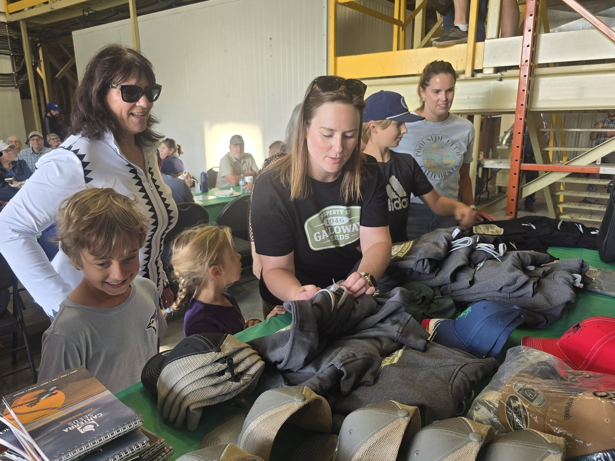Guests looking over gloves and gear on the display table