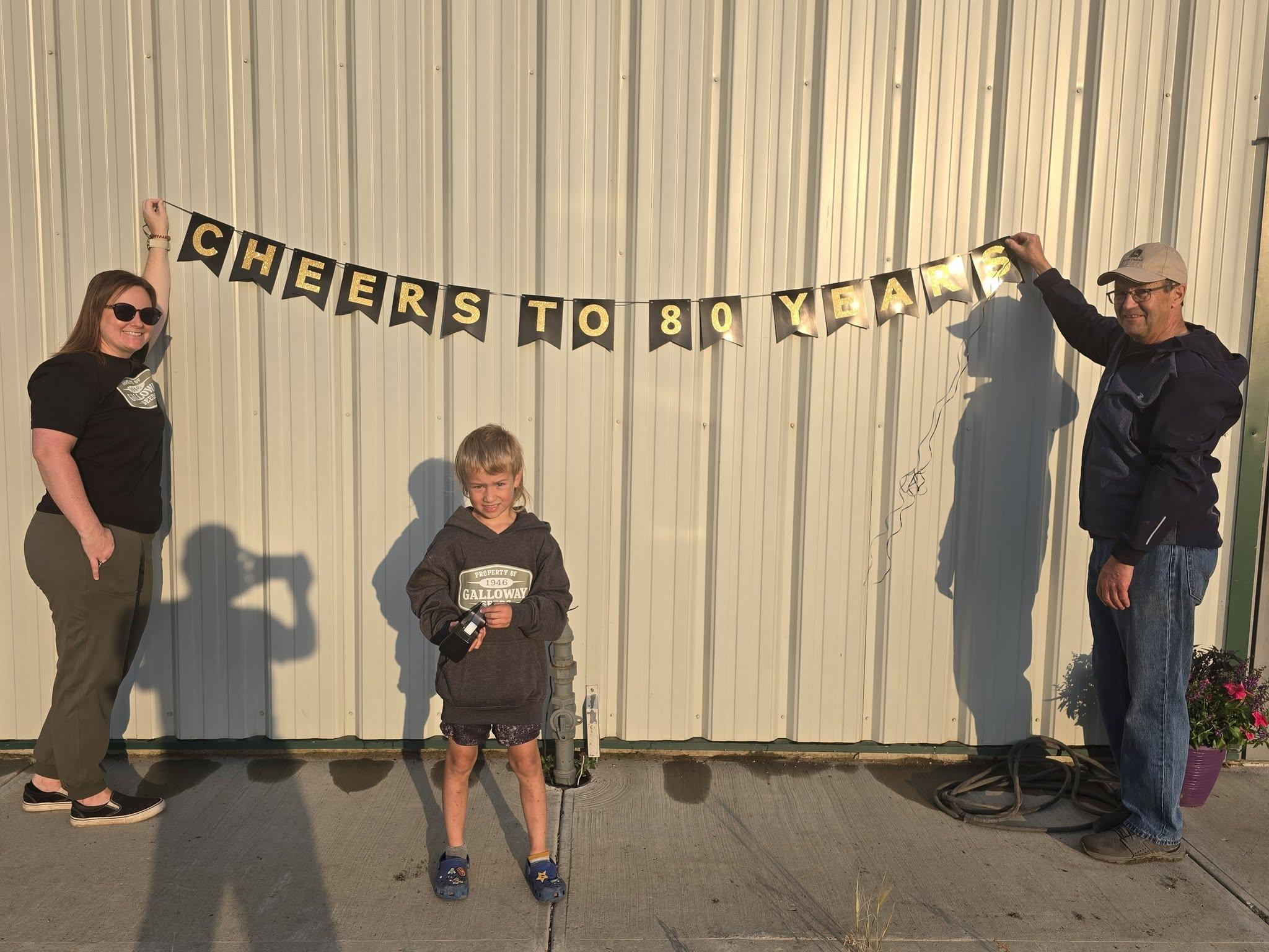 Hanging the Cheers to 80 Years banner before the doors opened