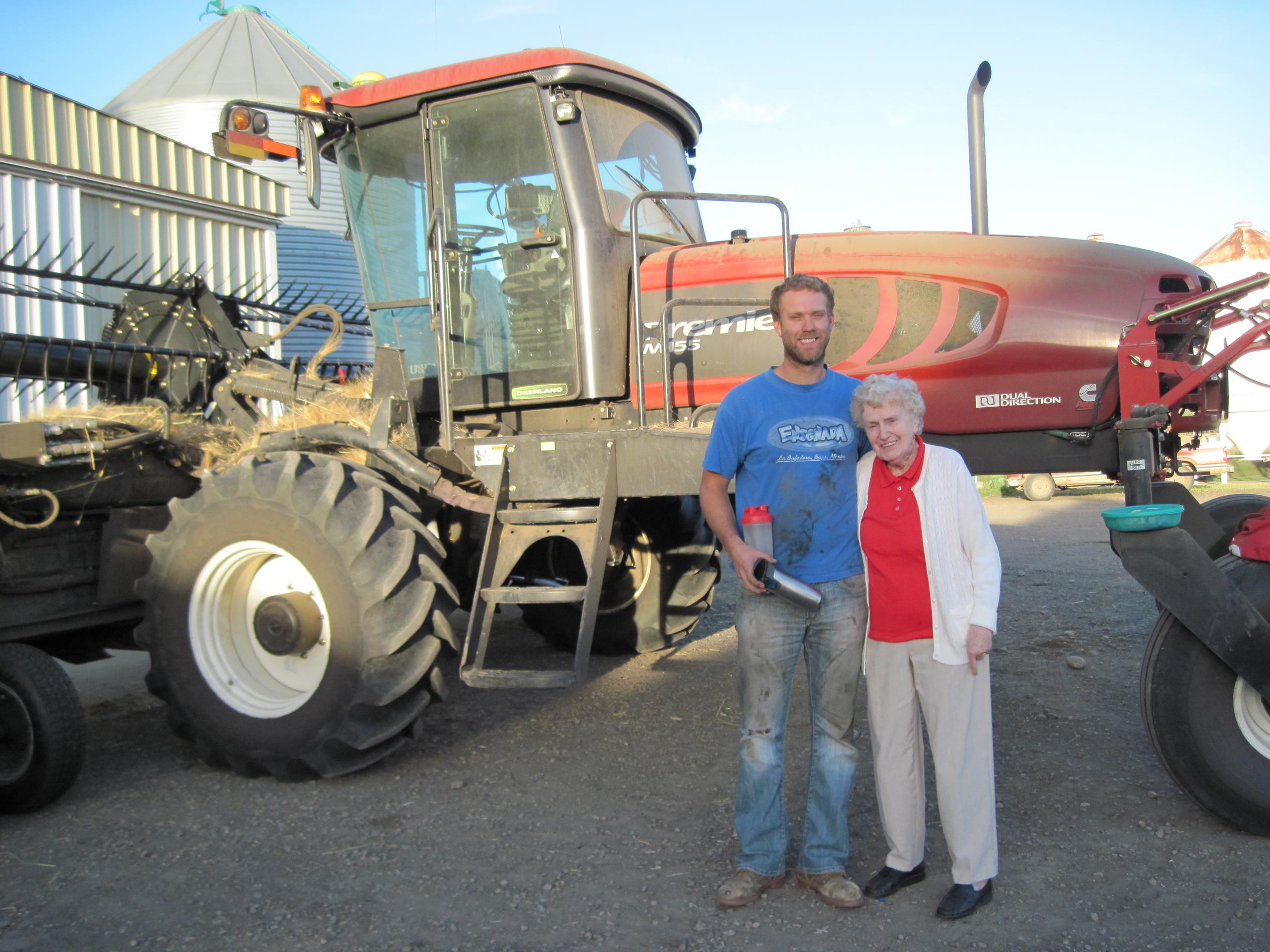 Two generations of the Galloway Seeds family in front of the swather
