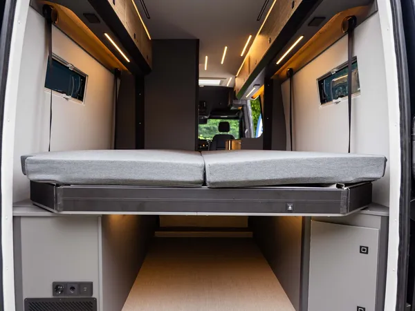 Roadstar XL Evo – Blick durch geöffnete Hecktüren auf Bett und großen Heckstauraum