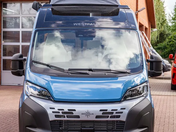 Columbus 540 D – Frontansicht eines blauen Westfalia Columbus mit geöffnetem Aufstelldach.