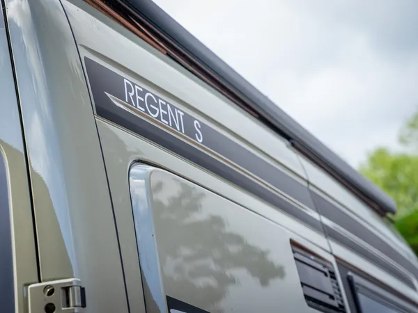 Regent S – Seitenansicht des Regent S Reisemobils mit Schriftzug und Markisenrolle