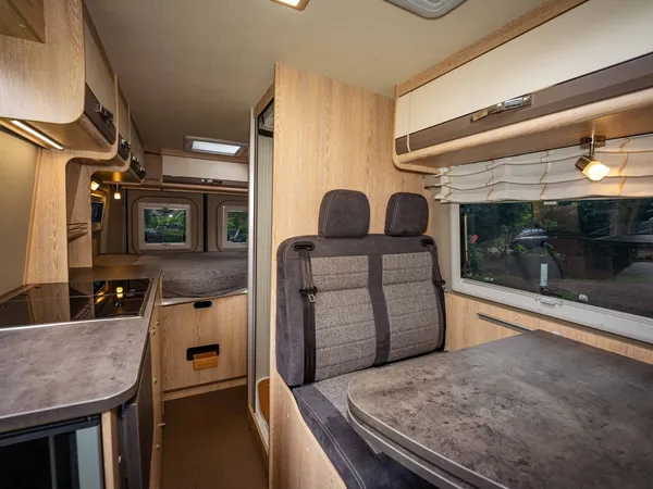 Summit 600 B – Innenansicht des Reisemobils mit Sitzgruppe, Küche und Bett.