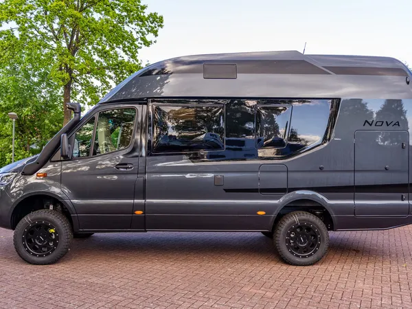 Nova M – Graues Reisemobil Nova M von der Seite, geparkt draußen.