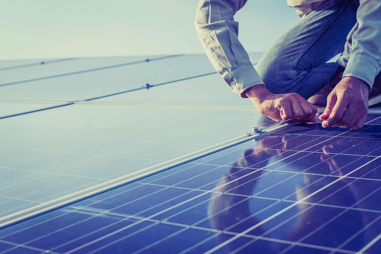 Electrician installing rooftop solar panels