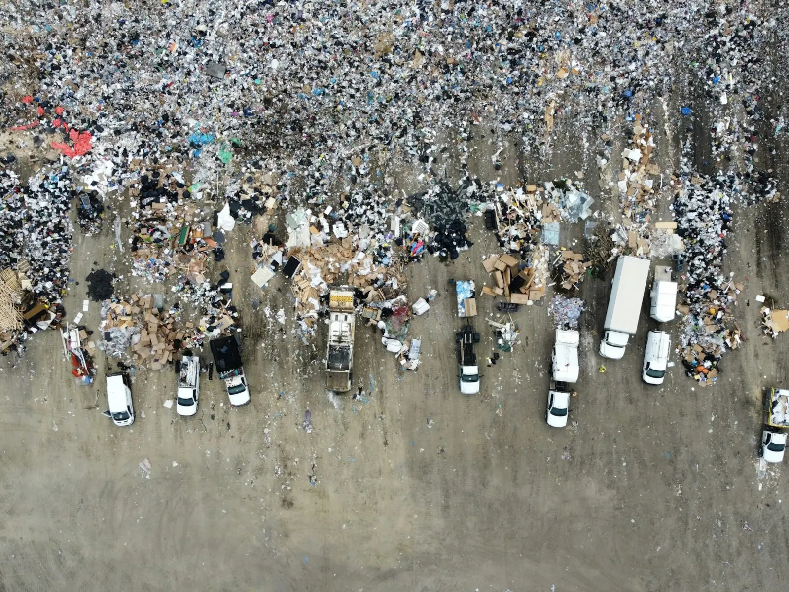 Aerial view of trucks unloading at a landfill site