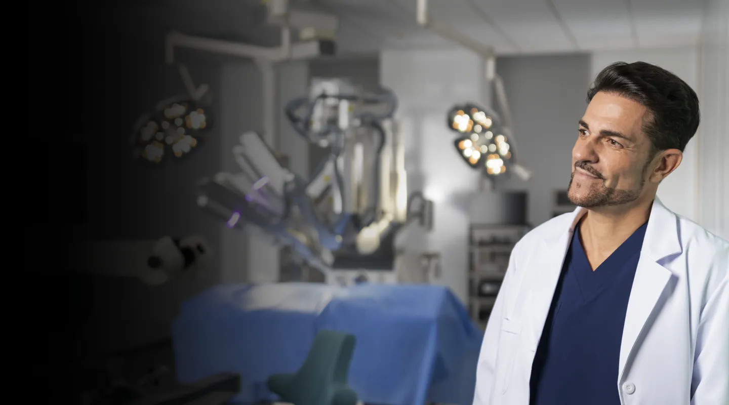 Surgeon in a white coat standing beside a SHURUI system in an operating theatre