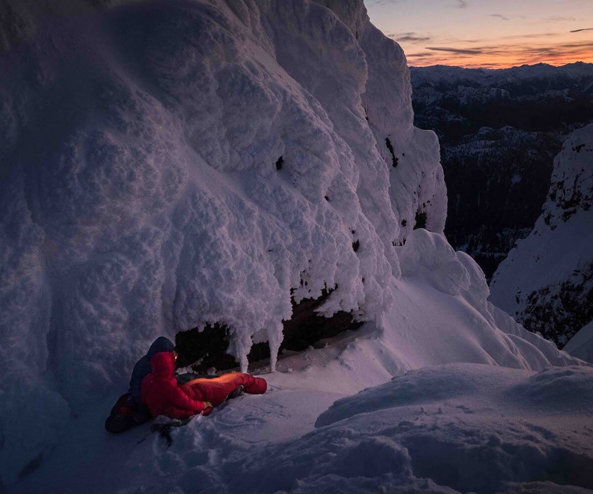 Two alpinists bivying in snowcovered mountains.