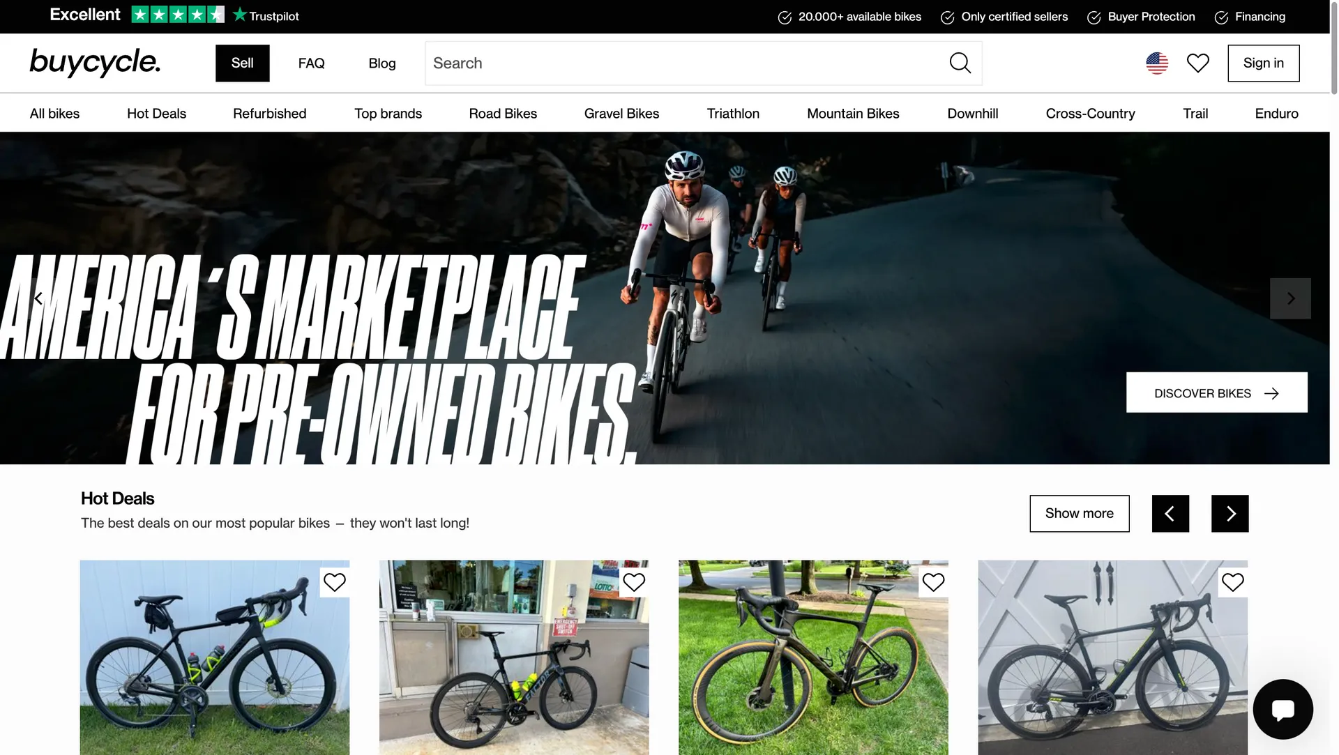 Website homepage showcasing pre-owned bikes with a banner image of cyclists on a road and a section featuring various bike deals.