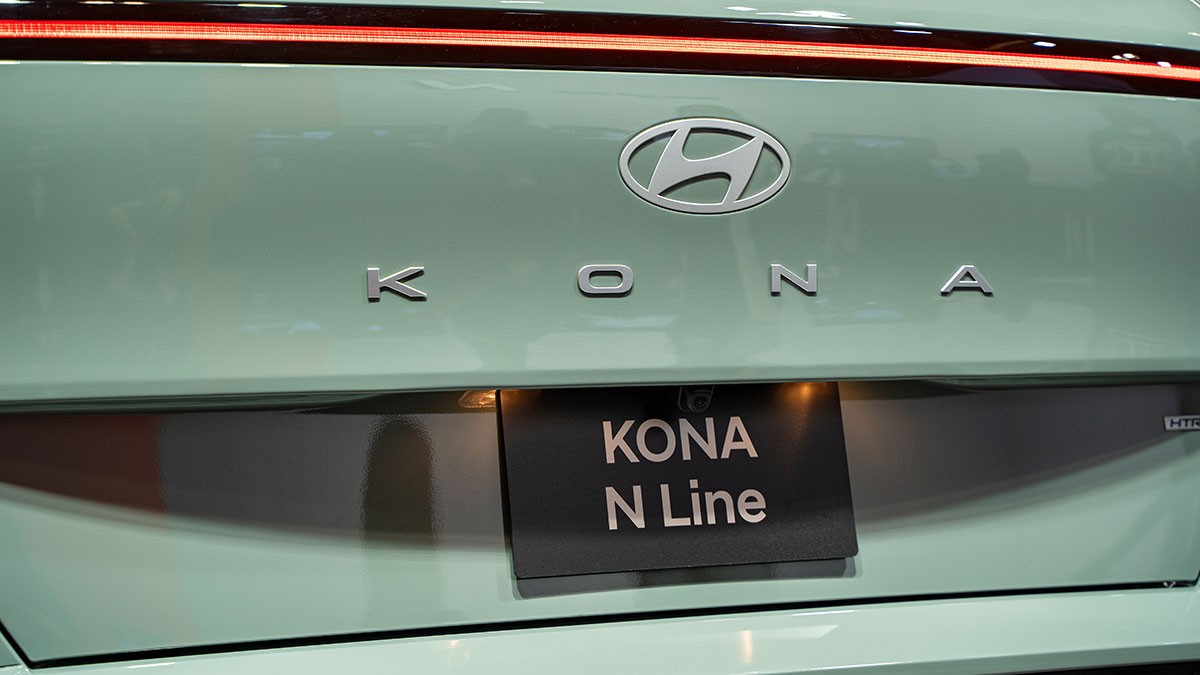 Close-up of a light green Hyundai Kona N Line's rear, showcasing the Hyundai logo and model name on the tailgate.