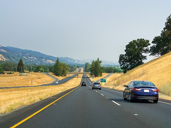 Highway running through rural California towards the mountains
