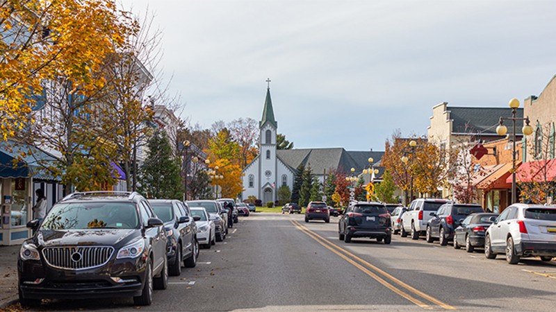 Michigan street with Autumn foliage in display and parked cars