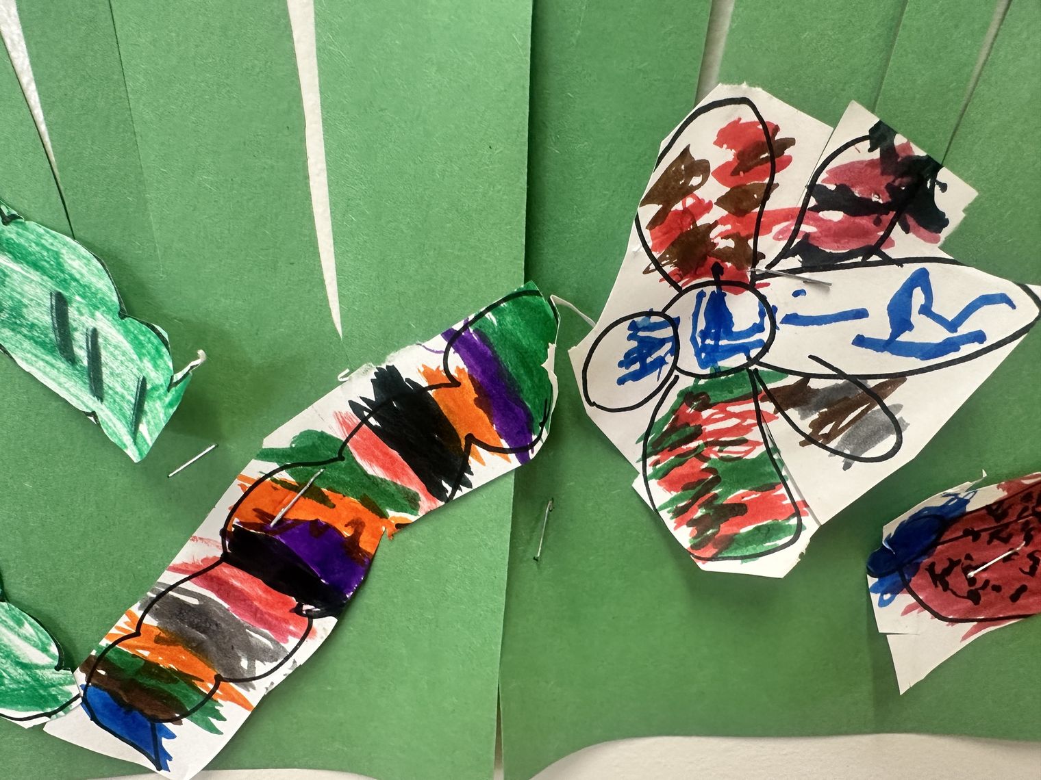 Colorful caterpillar and flower artwork made by preschoolers