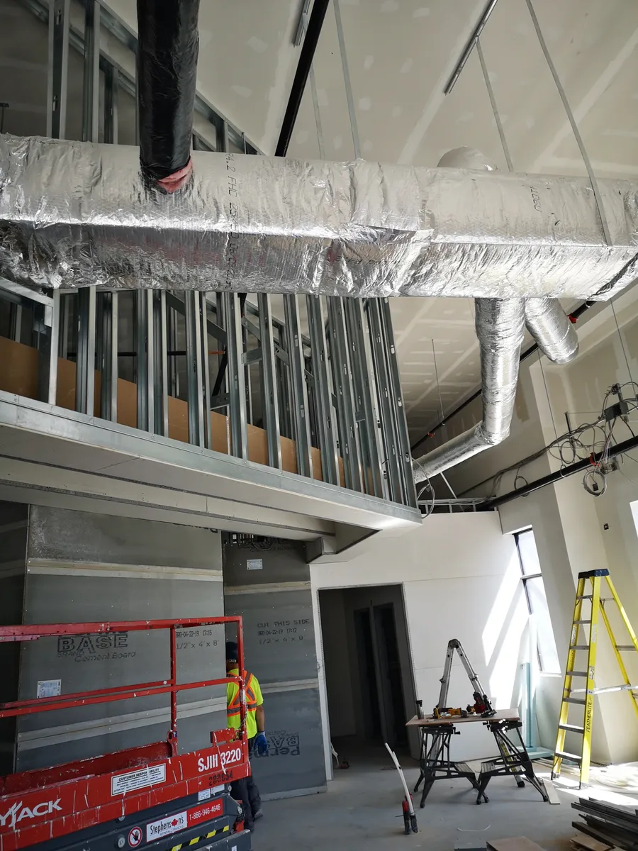 Interior structural-steel or mezzanine framing with duct and light-gauge framing coordination