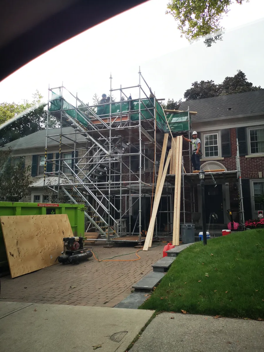 Exterior residential addition or facade structure with full-height scaffolding