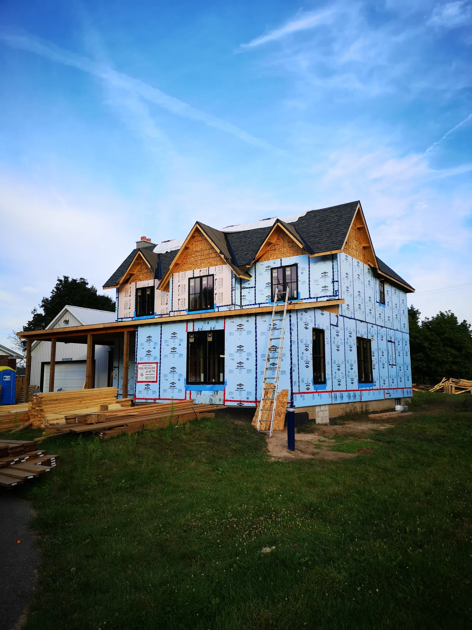 Two-storey custom-home wood framing and sheathing with multiple front gables