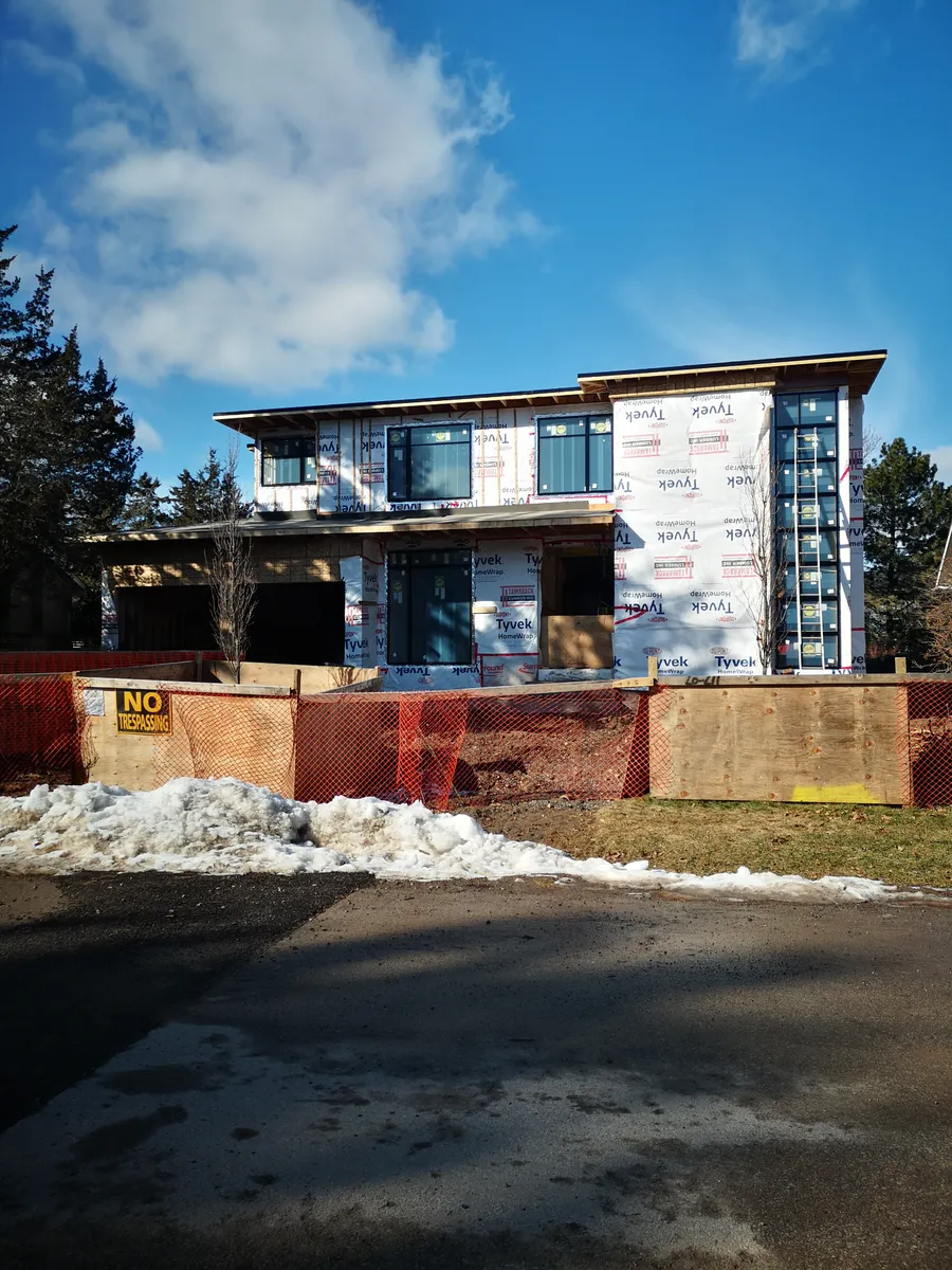 Two-storey custom-home shell with exterior sheathing and weather barrier