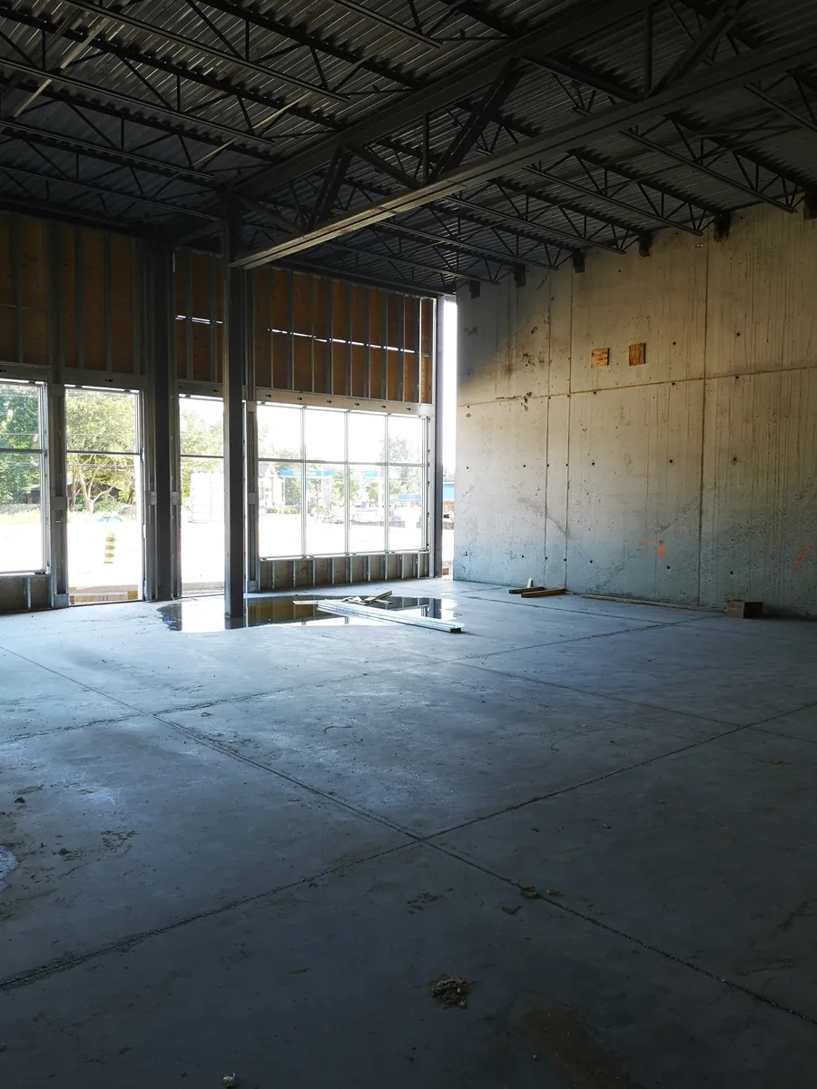 Unfinished structural shell with concrete/masonry surfaces and light-gauge steel framing