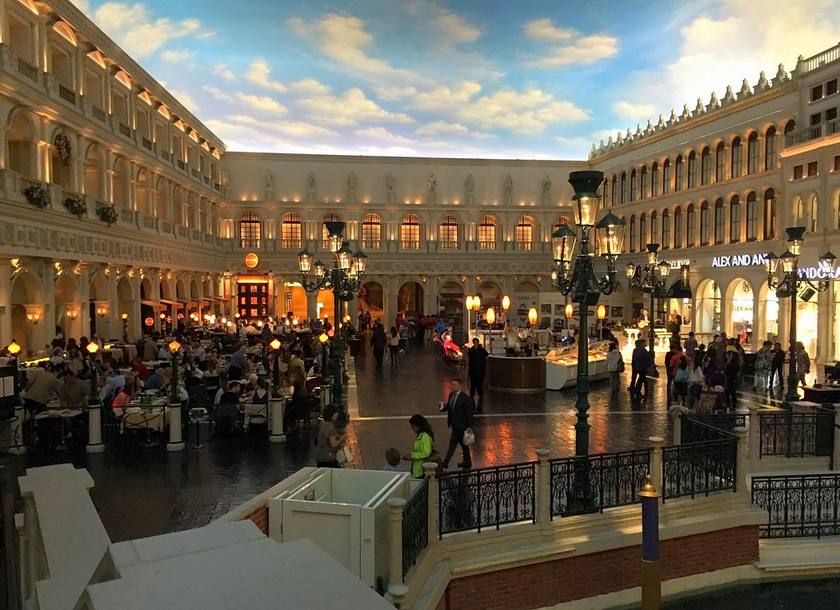 St. Mark's Square inside the Grand Canal Shoppes at The Venetian, with a painted sky ceiling, lamp posts and restaurant tables