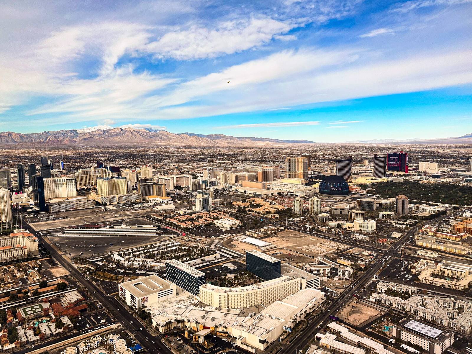 Aerial view of the Las Vegas Strip resorts from the east, with Sphere at center right and the Spring Mountains behind