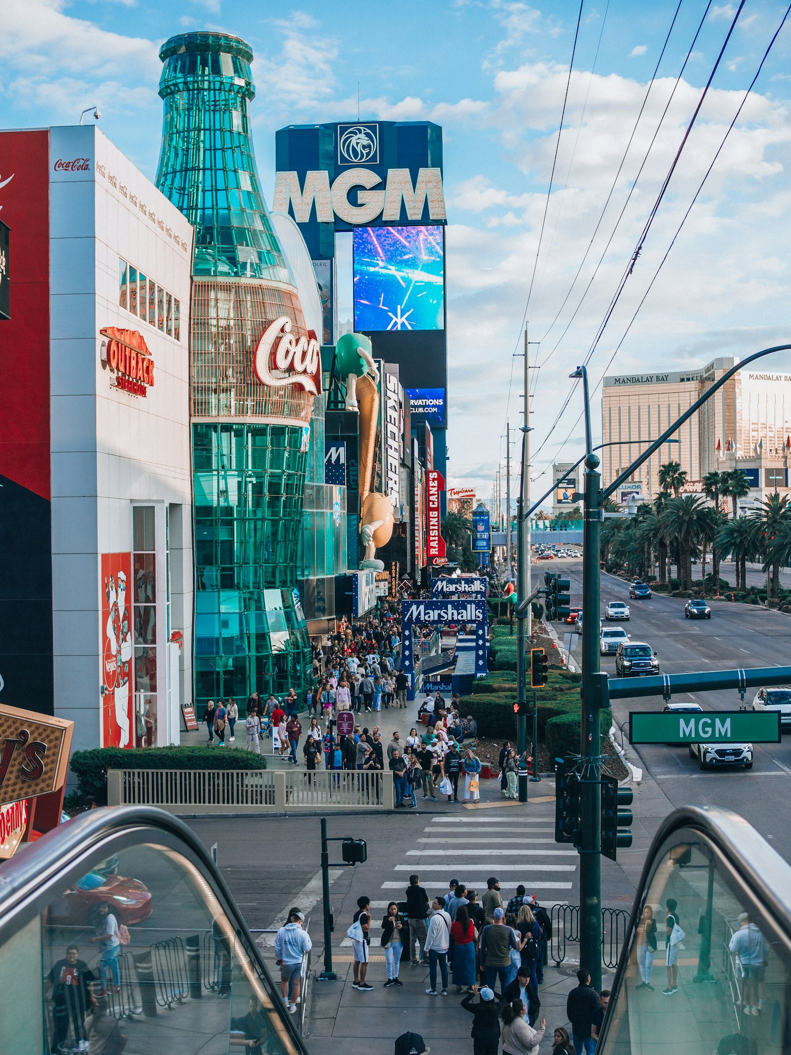 Crowd of people walking along a Las Vegas Strip sidewalk between tall resort buildings