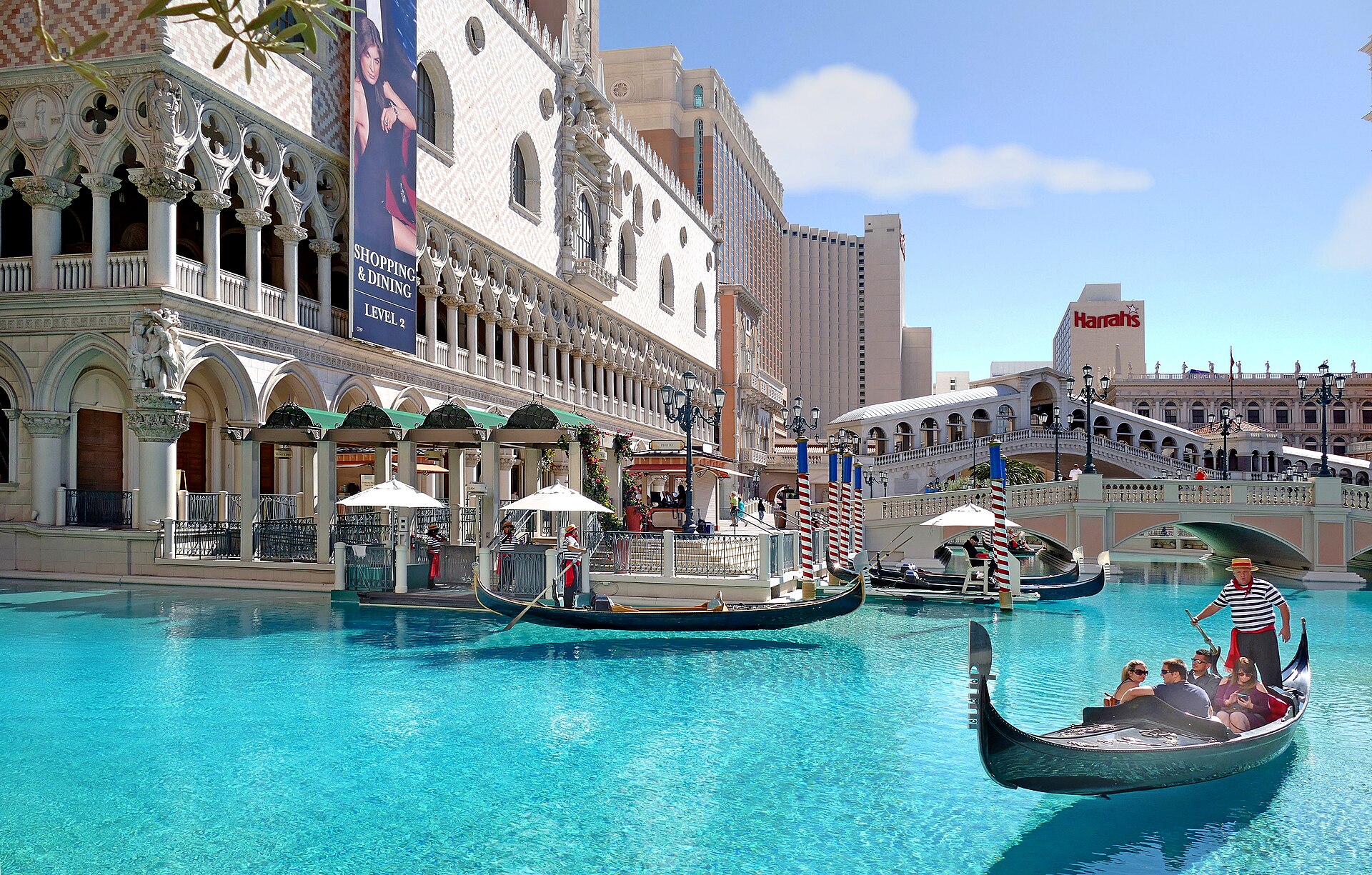 Gondolas on the outdoor canal at The Venetian Las Vegas beside the Doge's Palace replica and Rialto Bridge