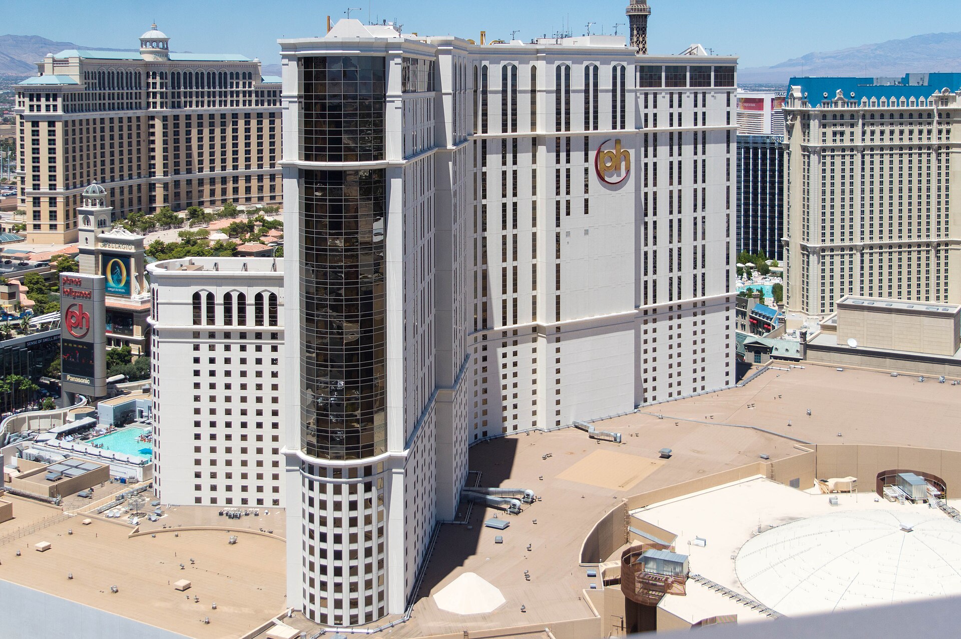 Planet Hollywood hotel tower seen from above, with Bellagio and the pool deck in the background