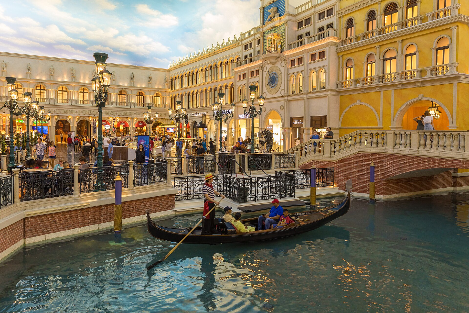 A gondolier rows visitors along the indoor canal past St. Mark's Square in the Grand Canal Shoppes