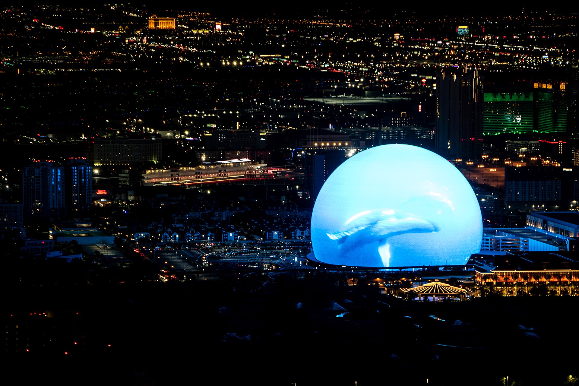 Sphere lit up at night, seen from high up on The STRAT tower