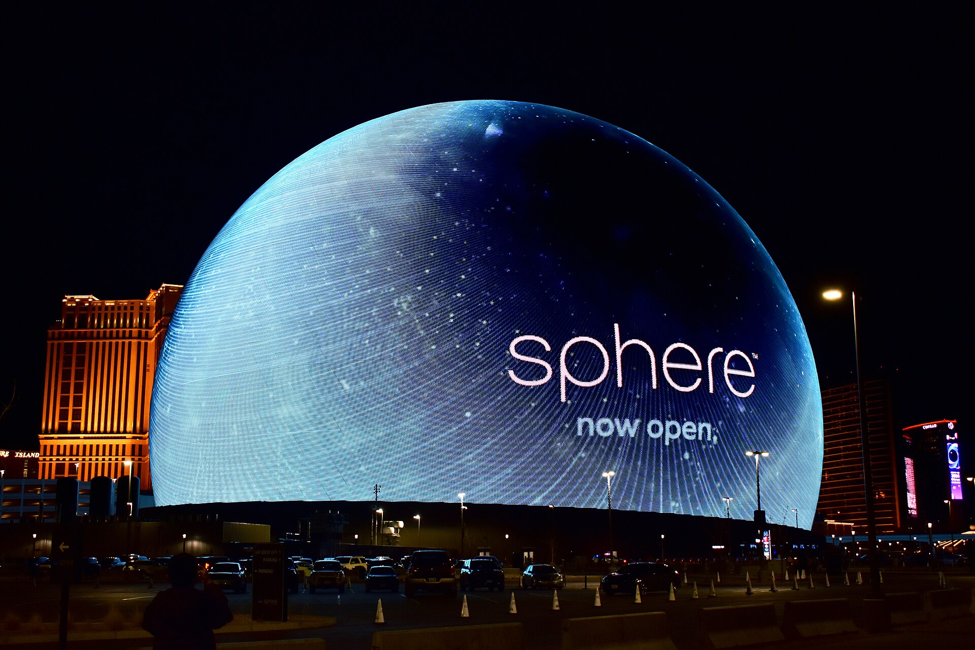 Sphere in Las Vegas lit up at night with a glowing blue Exosphere and the Sphere logo