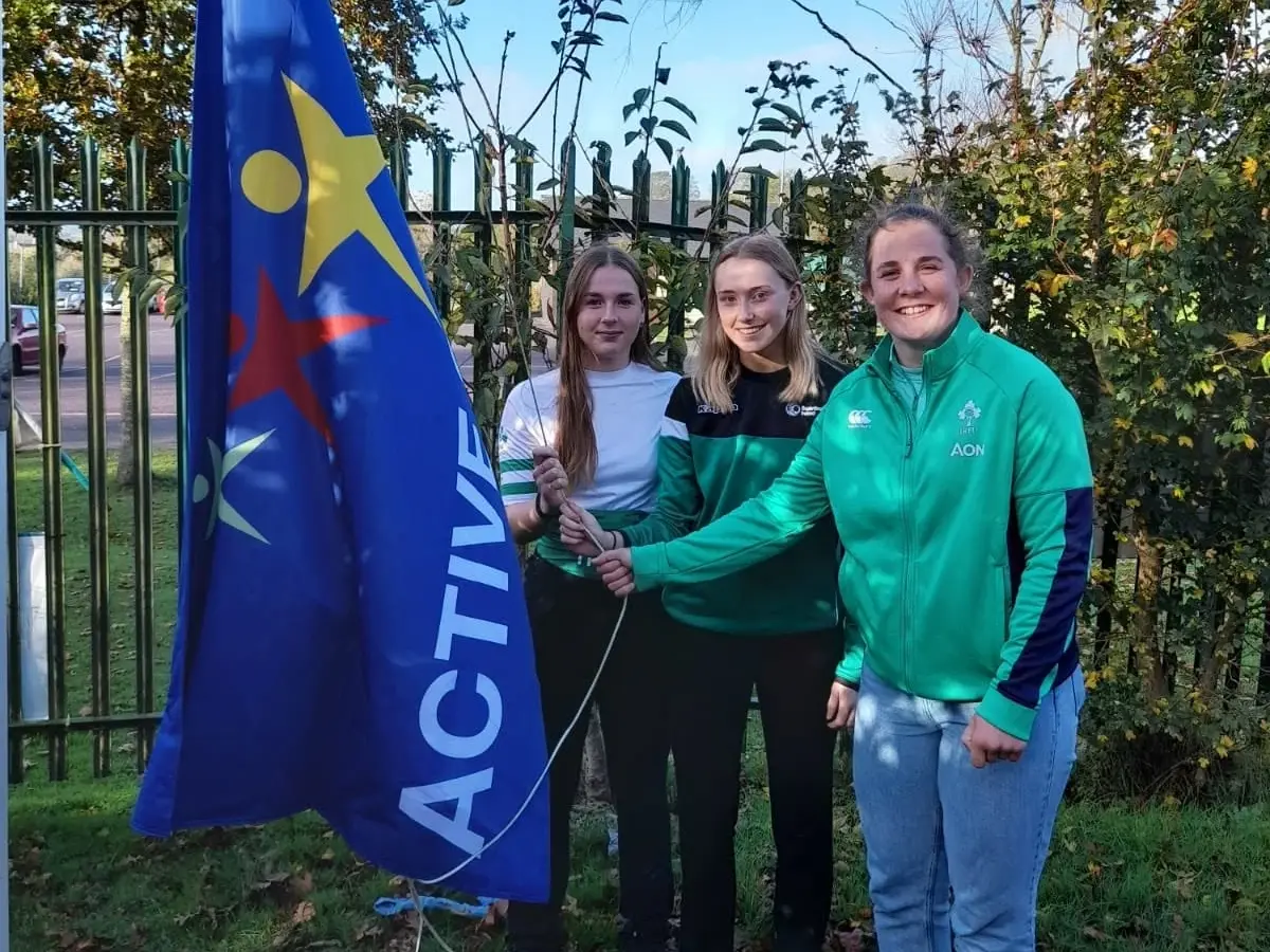 Raising the Active Flag on the school flagpole