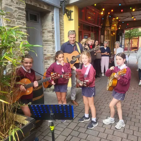 Pupils singing and playing guitar on the street at the Clonakilty International Guitar Festival (photo 7 of 7)