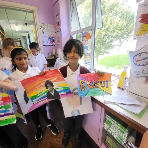 3rd Class pupils holding up their Getting to Know Me artwork (photo 3 of 14)