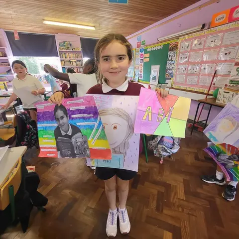 3rd Class pupils holding up their Getting to Know Me artwork (photo 5 of 14)
