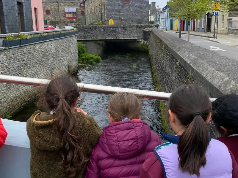 Pupils looking over a railing at the river in Clonakilty town