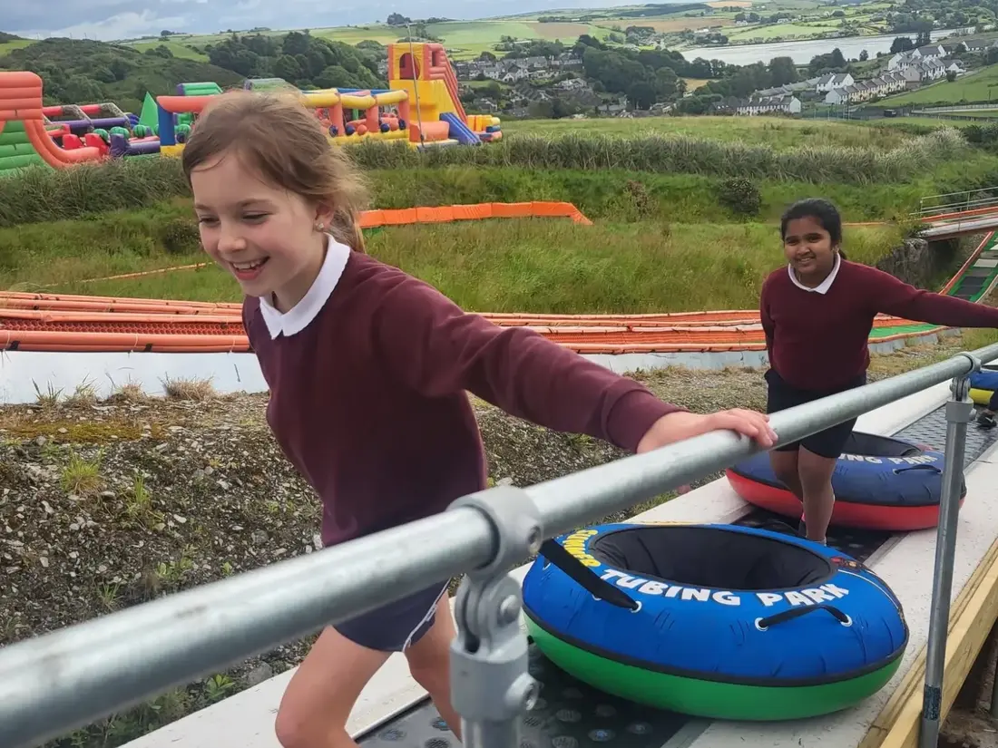 Pupils on the travelator at a tubing park on a school tour