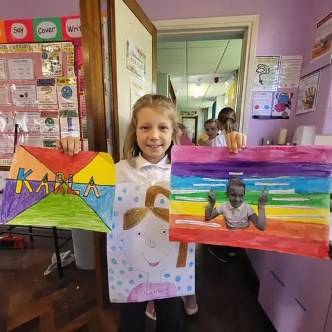 3rd Class pupils holding up their Getting to Know Me artwork (photo 11 of 14)