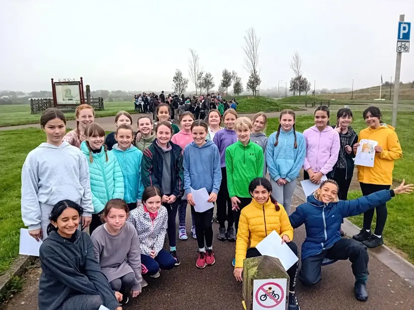Pupils with maps at an orienteering event