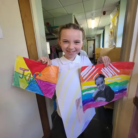 3rd Class pupils holding up their Getting to Know Me artwork (photo 13 of 14)