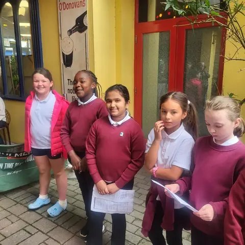 Pupils singing and playing guitar on the street at the Clonakilty International Guitar Festival (photo 5 of 7)