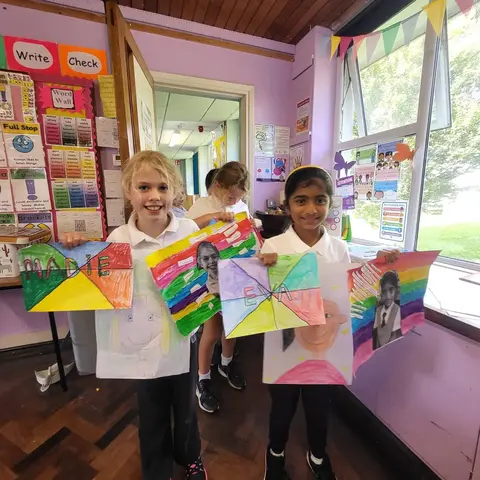 3rd Class pupils holding up their Getting to Know Me artwork (photo 7 of 14)