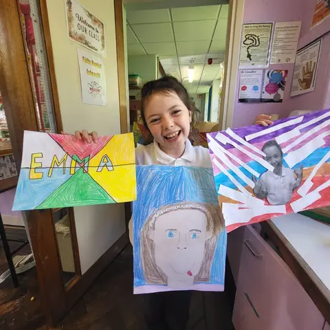 3rd Class pupils holding up their Getting to Know Me artwork (photo 9 of 14)