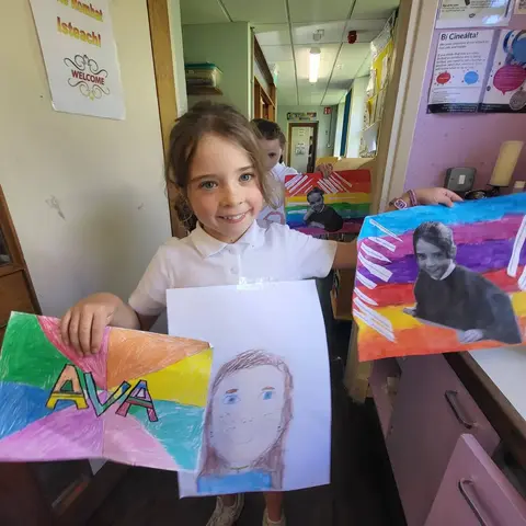 3rd Class pupils holding up their Getting to Know Me artwork (photo 12 of 14)