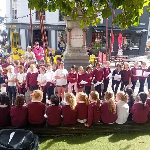 Pupils singing and playing guitar on the street at the Clonakilty International Guitar Festival (photo 2 of 7)